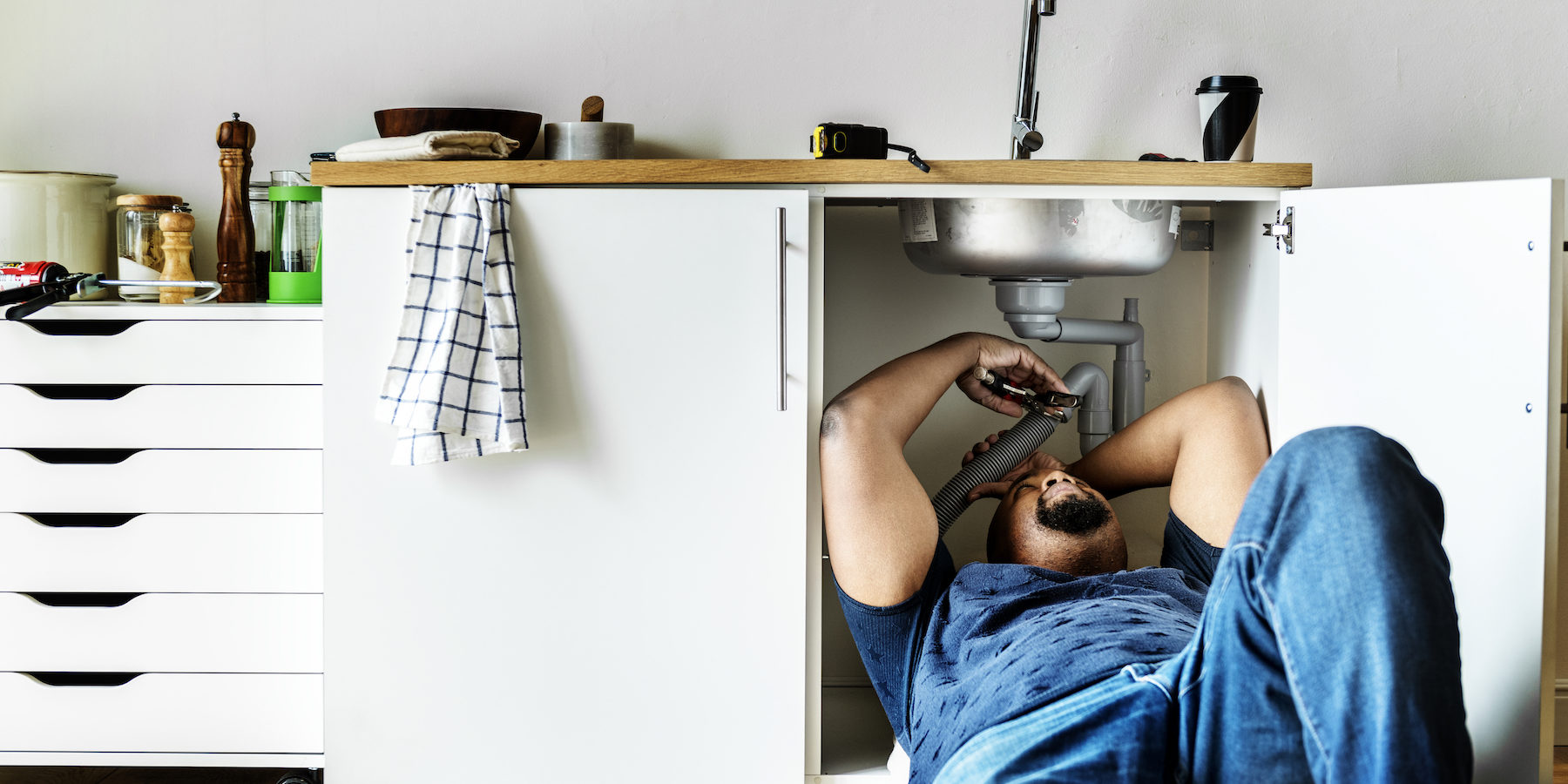 Plumber man fixing kitchen sink