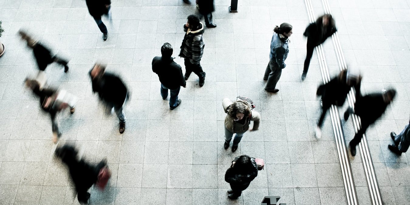 people walking on grey concrete floor