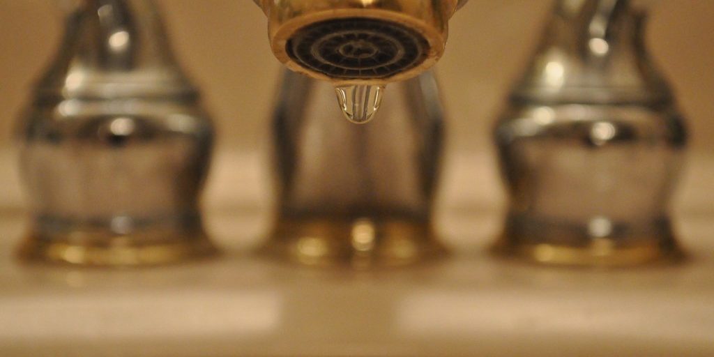 Close-up image of a dripping faucet
