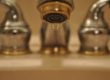 Close-up image of a dripping faucet