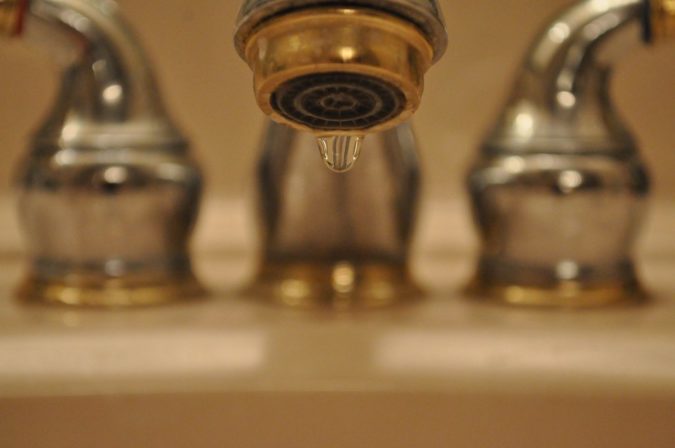 Close-up image of a dripping faucet