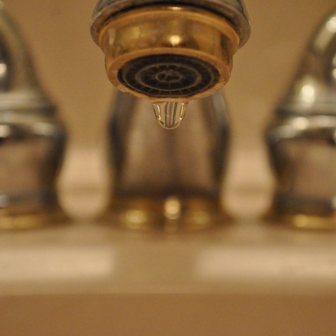 Close-up image of a dripping faucet