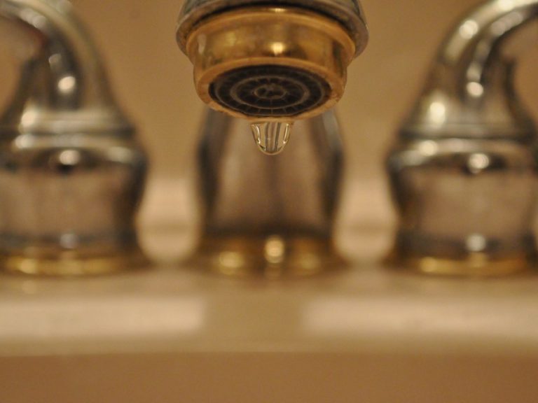 Close-up image of a dripping faucet