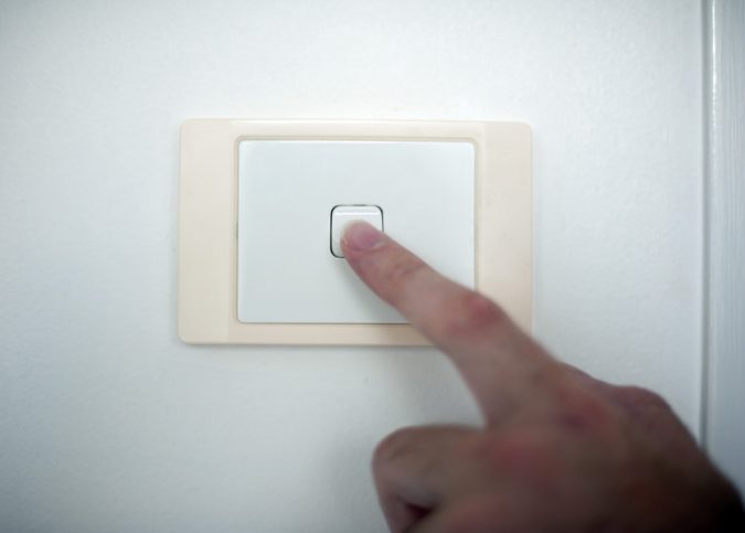 Finger switching on or off a light switch