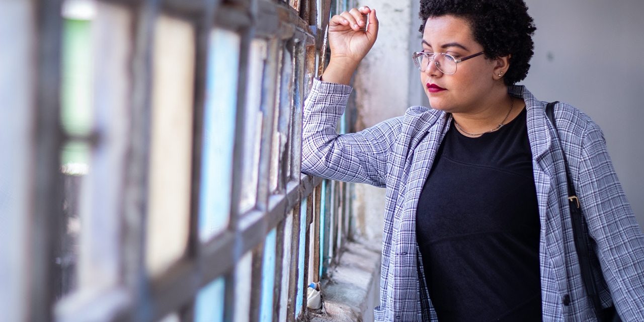 A woman looks out a window