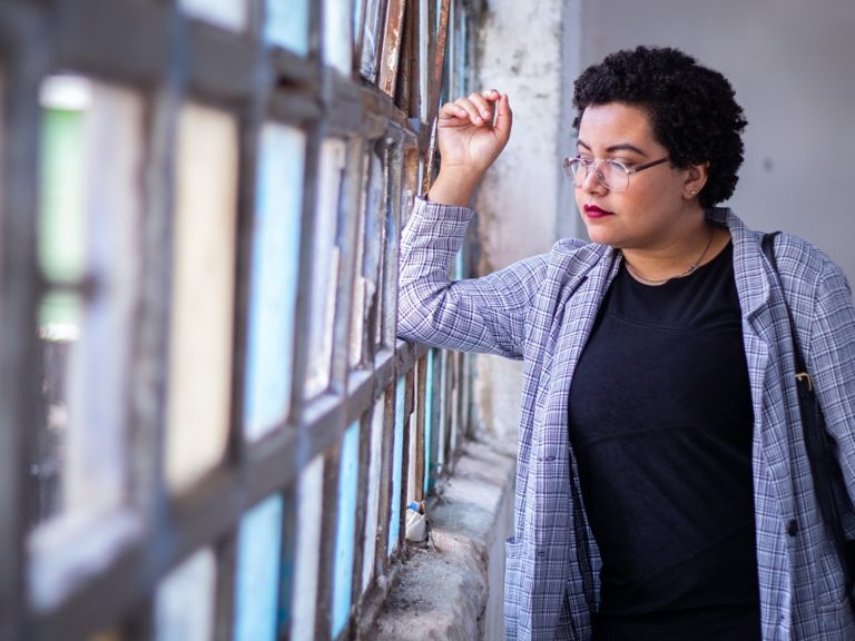 A woman looks out a window