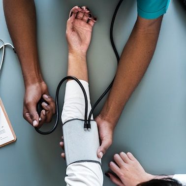 A doctor taking a patient's blood pressure
