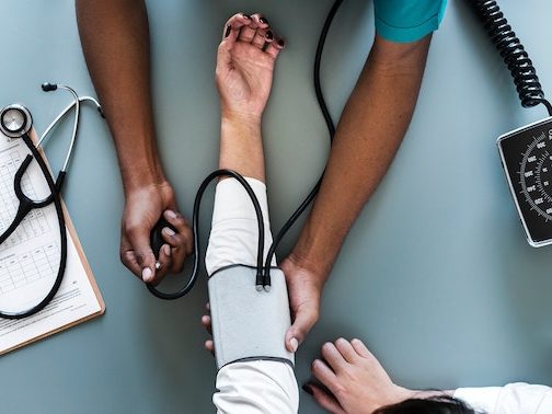 A doctor taking a patient's blood pressure