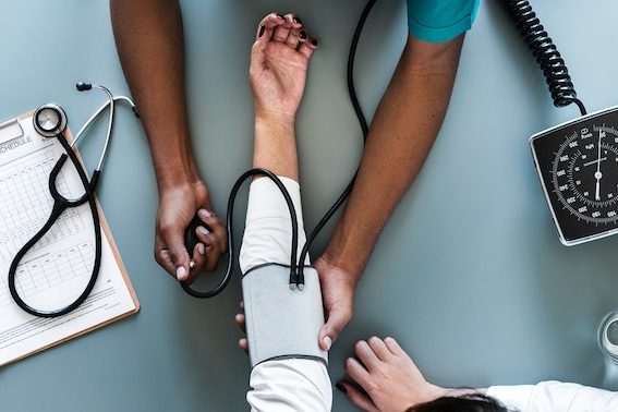 A doctor taking a patient's blood pressure