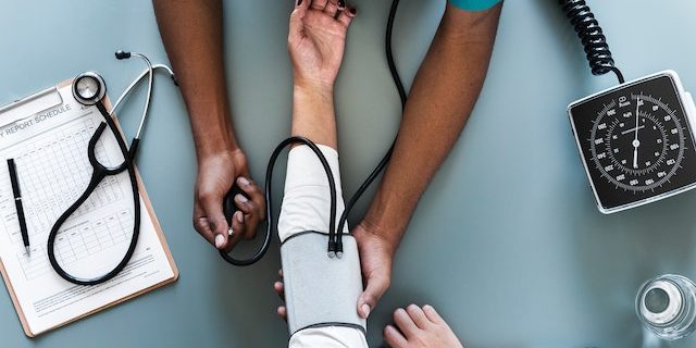 A doctor taking a patient's blood pressure